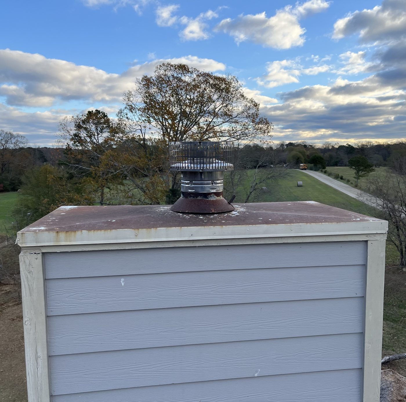 Rusted rain pan on chimney cap